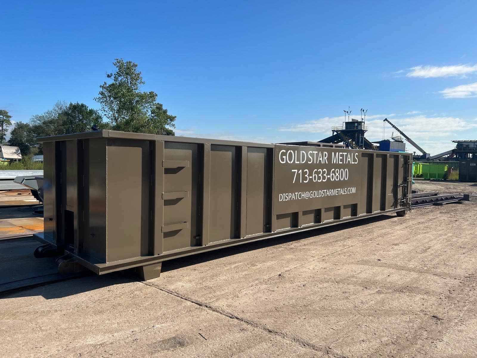 GSM-branded roll-off container ready for placement at a business site